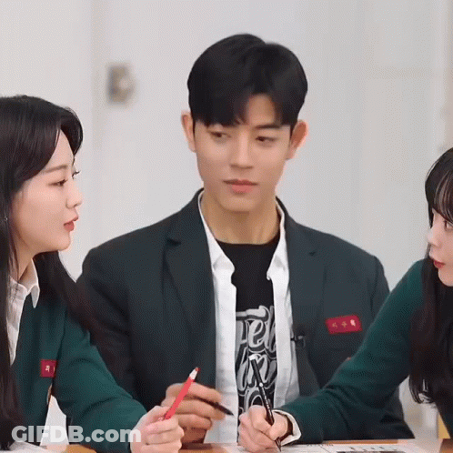 Man In Suit Holding Red Pencil With Two Girls GIF