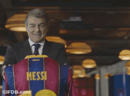 Man In Suit Holding Shirt With Number 10 GIF