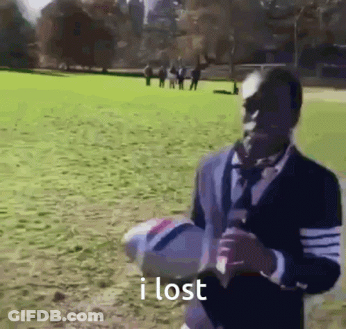 Man In Suit Holding Soccer Ball In Field GIF