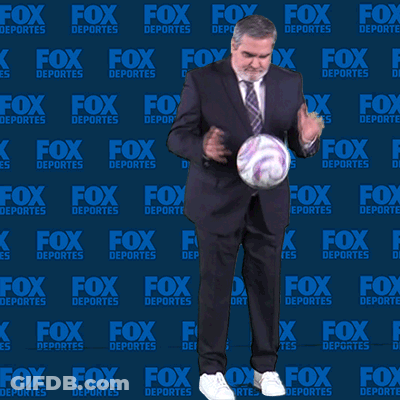 Man In Suit Holding Soccer Ball In Front Of Fox Deportes Wall GIF
