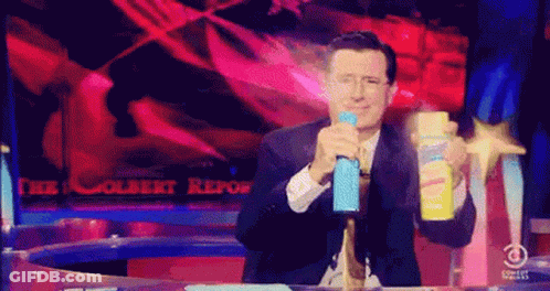 Man In Suit Holding Spray Bottle GIF