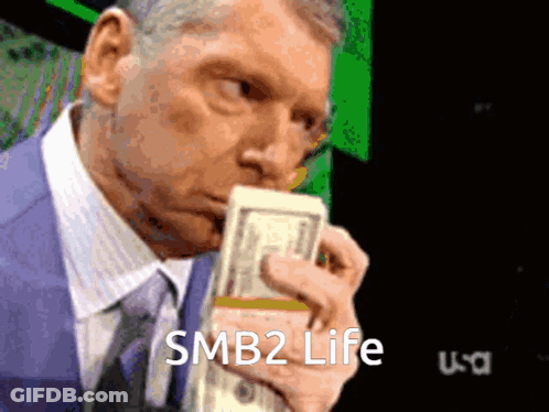 Man In Suit Holding Stack Of Money Saying SMB2 Life GIF