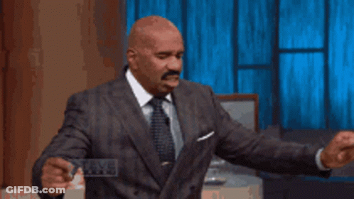 Man In Suit Holding Steve Harvey Card GIF