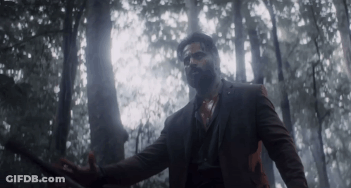 Man In Suit Holding Sword In Forest GIF