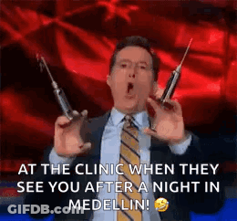 Man In Suit Holding Syringes GIF