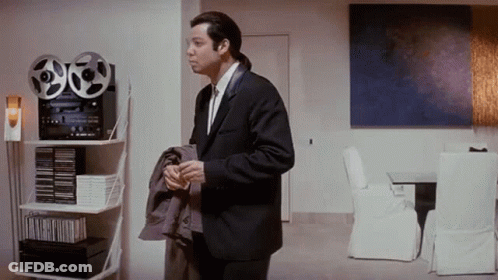 Man In Suit Holding Tape Recorder In Living Room GIF
