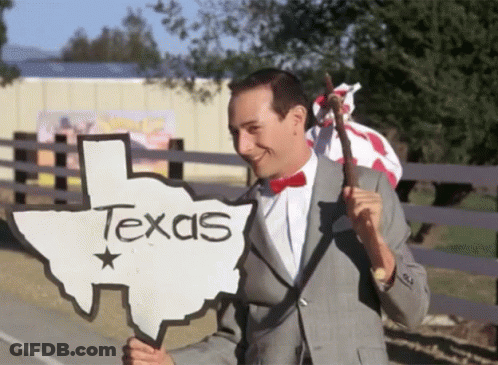 Man In Suit Holding Texas Sign GIF