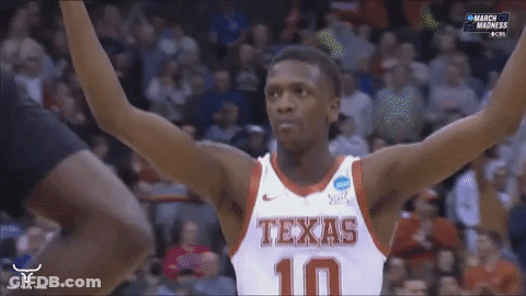 Man In Suit Holding Texas Sign GIF