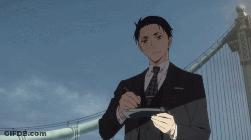 Man In Suit Holding Tokyo Sign GIF