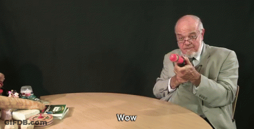 Man In Suit Holding Toy Gun Saying Wow GIF