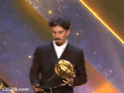Man In Suit Holding Trophy GIF