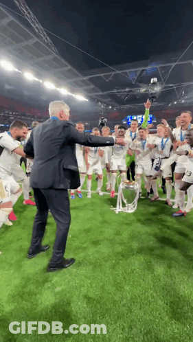 Man In Suit Holding Trophy GIF