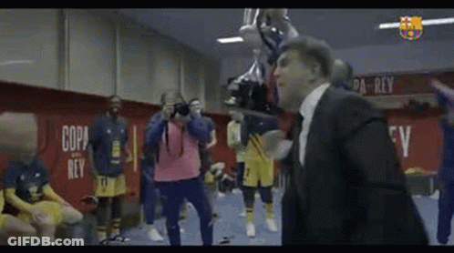 Man In Suit Holding Trophy In Locker Room GIF