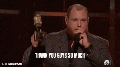 Man In Suit Holding Trophy Singing Into Microphone Saying Thank You Guys So Much GIF