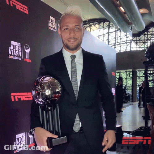 Man In Suit Holding Trophy Tmeb Wall GIF
