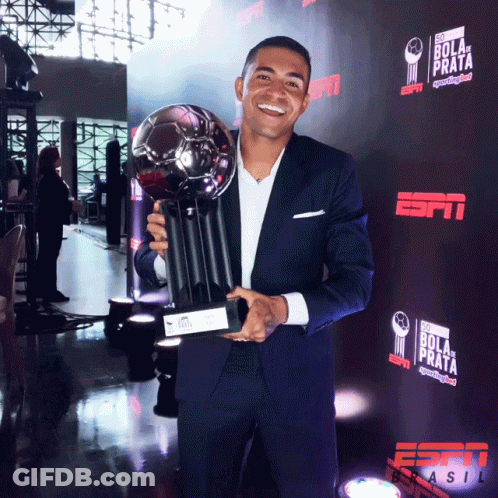 Man In Suit Holding Trophy GIF