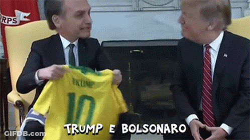 Man In Suit Holding Trump 10 Shirt GIF