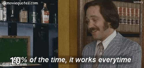 Man In Suit Holding Vodka By Bookshelf GIF