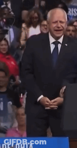 Man In Suit Holding We Win Sign GIF