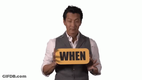 Man In Suit Holding When Sign GIF