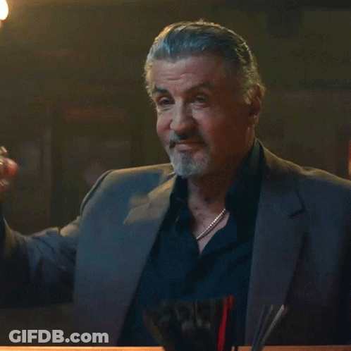 Man In Suit Holding Whiskey Glass GIF