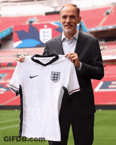 Man In Suit Holding White Nike Jersey GIF