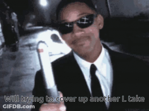 Man In Suit Holding White Object Saying Will Trying To Cover Up Another L Take GIF