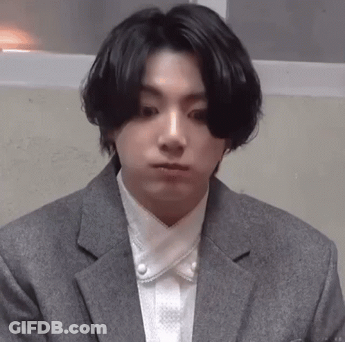 Man In Suit Holding White Towel Around Waist GIF