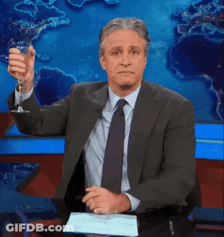 Man In Suit Holding Wine Glass In Front Of World Map GIF