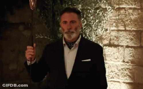 Man In Suit Holding Wine Glass GIF