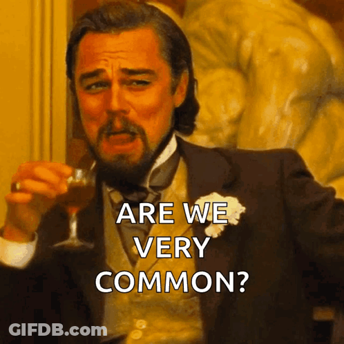 Man In Suit Holding Wine Glass Saying Are We Very Common GIF