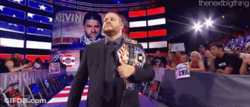Man In Suit Holding World Heavyweight Championship Belt GIF