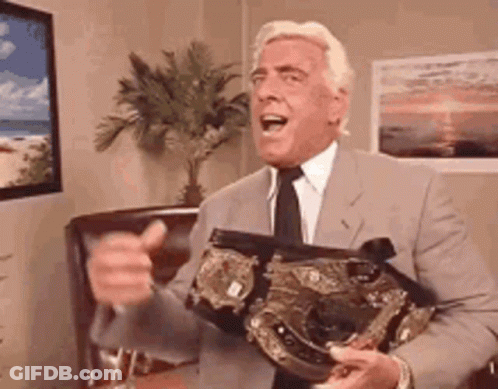 Man In Suit Holding Wrestling Belt GIF