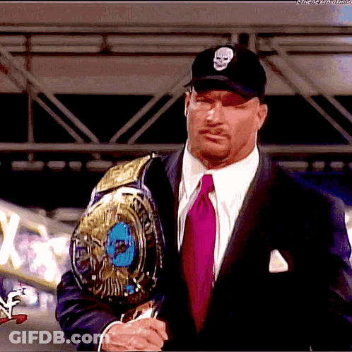 Man In Suit Holding Wrestling Belt GIF