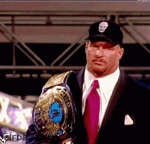 Man In Suit Holding Wrestling Championship Belt GIF