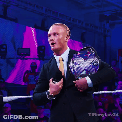 Man In Suit Holding WWE Championship Belt GIF