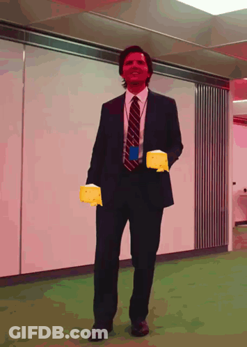 Man In Suit Holding Yellow Glove GIF