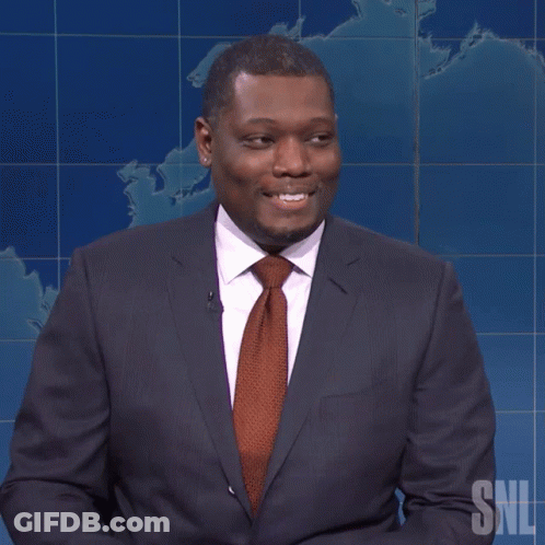 Man In Suit Holding Yellow Pencil With SNL Logo GIF