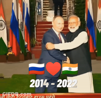 Man In Suit Hugging Another Man In Front Of Flags 2014-2022 GIF