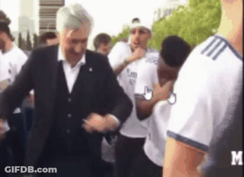Man In Suit In Crowd With Letter M GIF