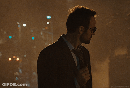Man In Suit In Dark Alleyway With Daredevilshots GIF