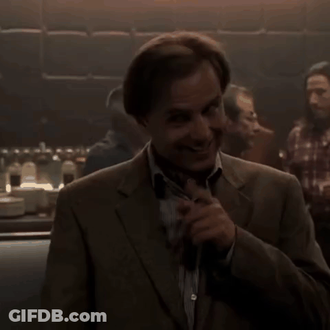 Man In Suit In Dark Room GIF