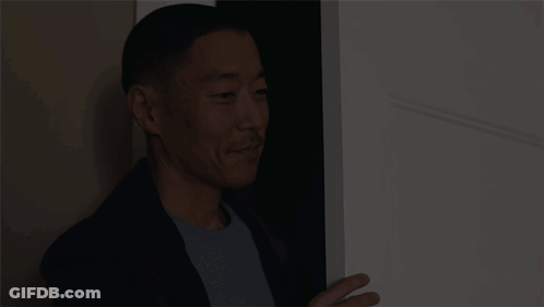 Man In Suit In Doorway GIF