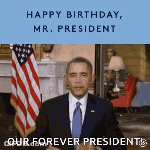Man In Suit In Front Of American Flag Saying Happy Birthday Mr President GIF