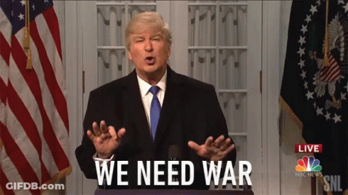 Man In Suit In Front Of American Flag Says We Need War GIF