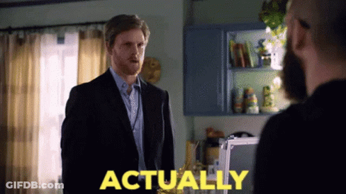 Man In Suit In Front Of Another Man With Actually In Yellow GIF