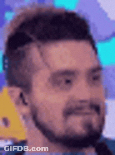 Man In Suit In Front Of Assistants Plateau Screen GIF