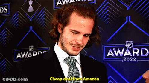 Man In Suit In Front Of Awards 2022 Wall GIF