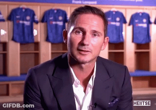 Man In Suit In Front Of Blue Shirts GIF