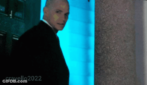 Man In Suit In Front Of Blue Wall 2022 GIF